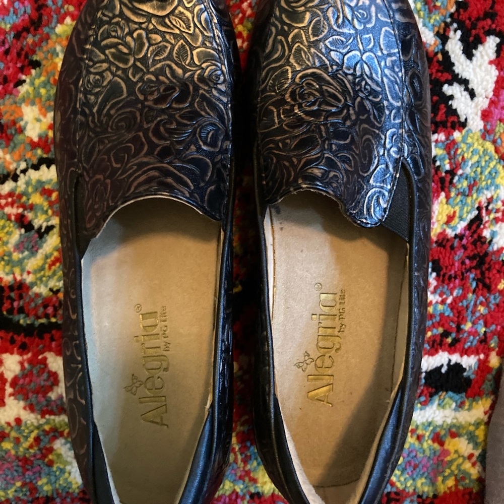 These are Alegria by PG Lite branded shoes. They are brown with roses.
